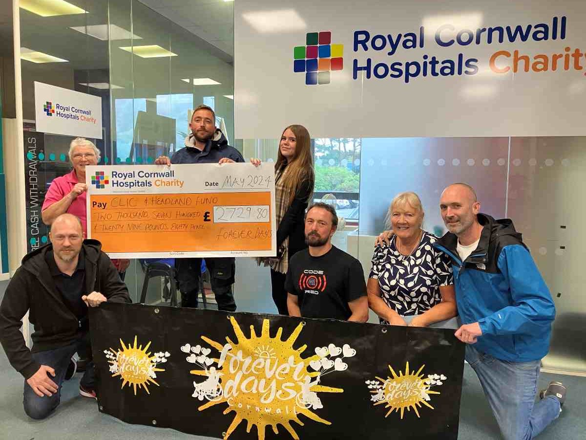 A giant cheque for £2,729.80 being presented to the Royal Cornwall Hospitals Charity by fundraisers from the Forever Days charity.